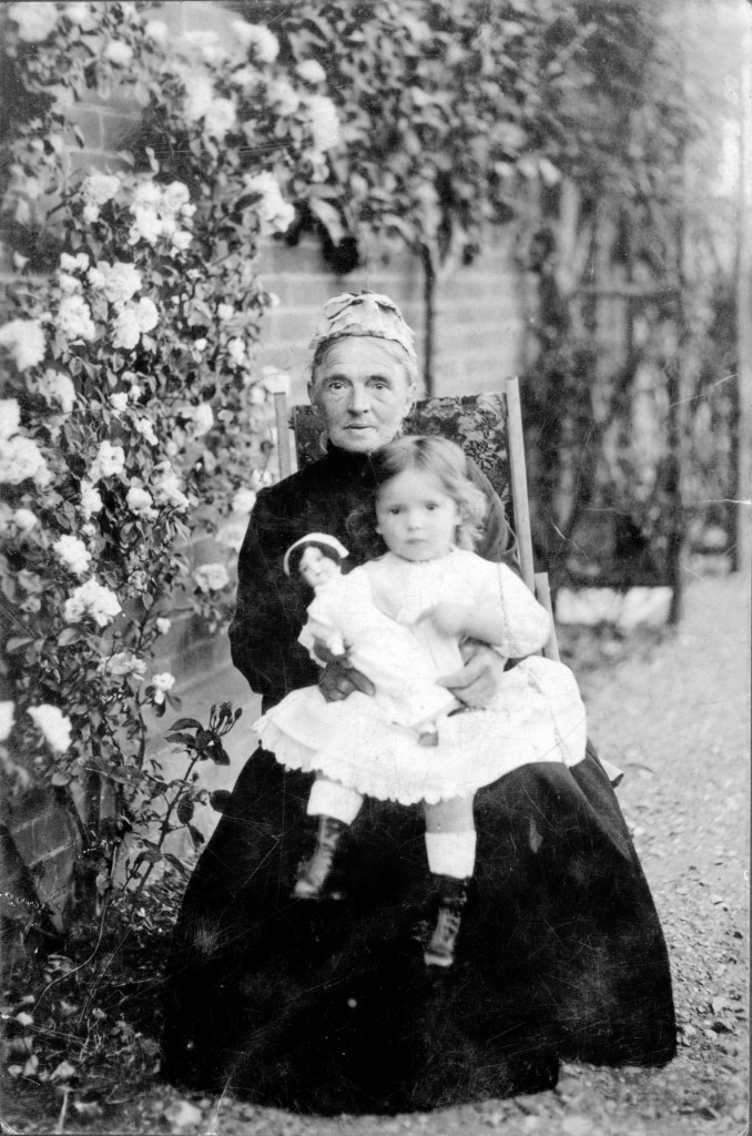 'Lady in walled garden' appears to have been taken at the same time as the Corporal shot (probably Arthur) in the Great War page - definitely an older generation - his mum perhaps?  If so, who is the toddler?